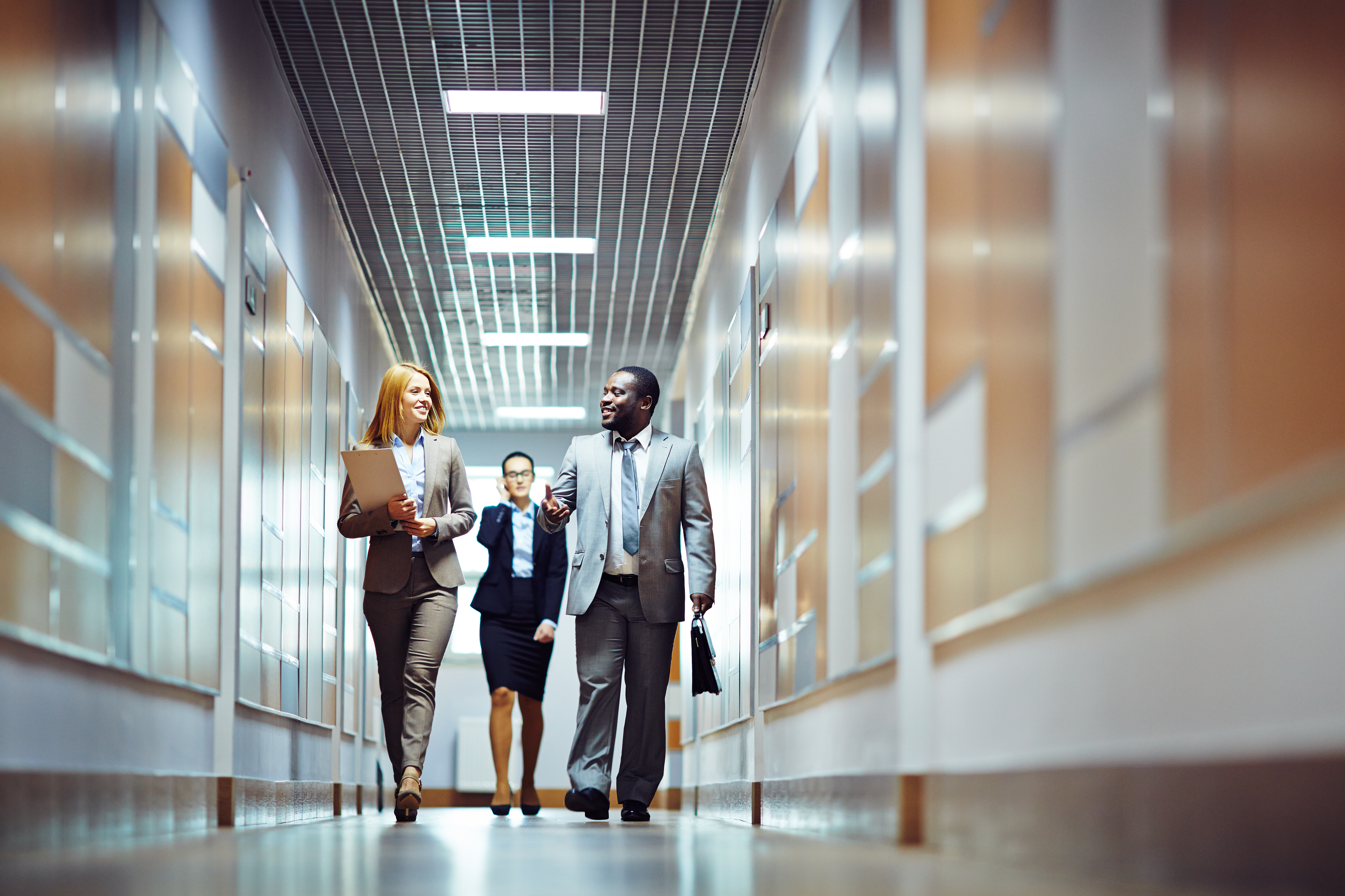 Team collaborating in an office corridor